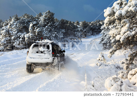 One SUV 4x4 cars go on snowy road, winter season One SUV 4x4 cars go on snowy road, winter season 72793441