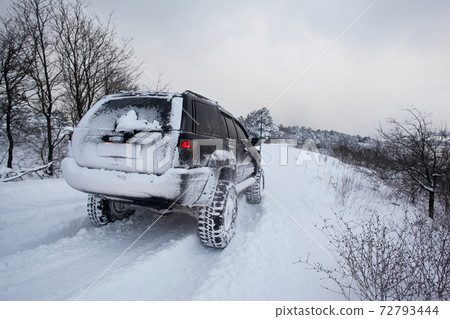 One SUV 4x4 cars go on snowy road, winter season One SUV 4x4 cars go on snowy road, winter season 72793444
