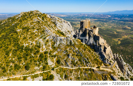 Drone view of ruins of Castle de Queribus on stone peak, France 72801072
