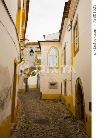 Narrow streets in Evora city with old buildings in Spain, nobody 72801629