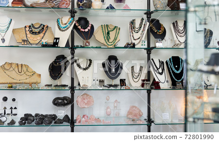 Semiprecious stones jewelry in showcase of shop 72801990