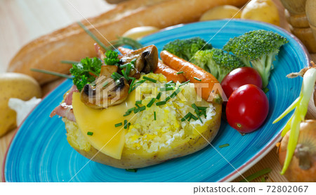 Baked potatoes with bacon, cheese, champignons, vegetables 72802067