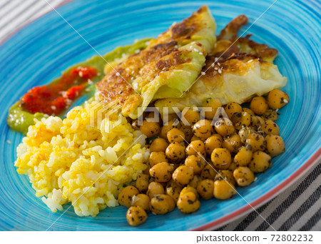 Vegetarian dish of leaves of cabbage in batter with sauces and chickpea Vegetarian dish of leaves of cabbage in batter with sauces and chickpea 72802232
