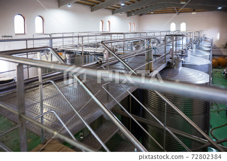 Interior of winery with stainless steel tanks Interior of winery with stainless steel tanks 72802384