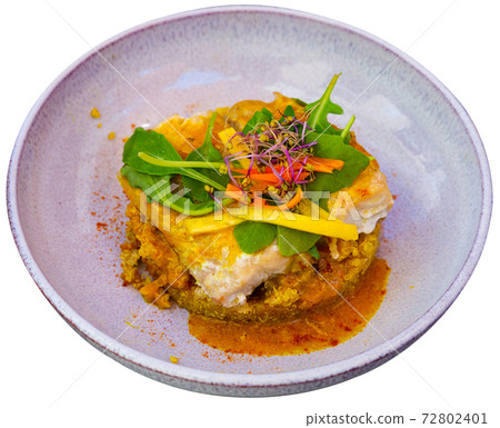 Codfish baked with curry and served with quinoa and greens Codfish baked with curry and served with quinoa and greens 72802401