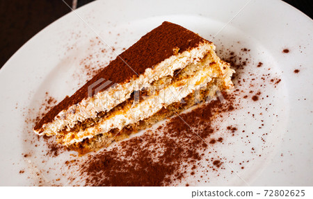 Sponge cake with butter cream and chocolate powder Sponge cake with butter cream and chocolate powder 72802625
