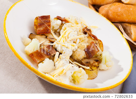 Dish of tasty baked cauliflower with potatoes, brisket meat and cheese sauce Dish of tasty baked cauliflower with potatoes, brisket meat and cheese sauce 72802633