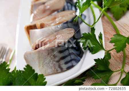Mild-cured scomber on plate with greens 72802635
