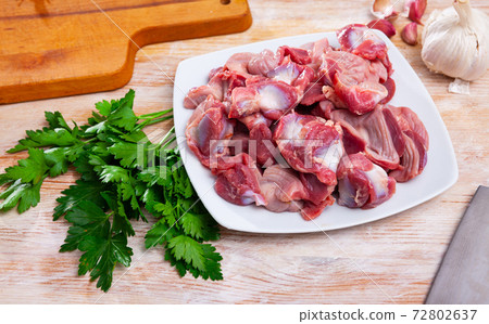Raw chicken gizzards with greens and spices Raw chicken gizzards with greens and spices 72802637