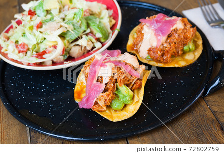 Image of tasty chicken salad with avocado and tuna tostada Image of tasty chicken salad with avocado and tuna tostada 72802759