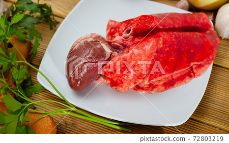 Raw lamb lungs and heart served with greens, nobody 72803219