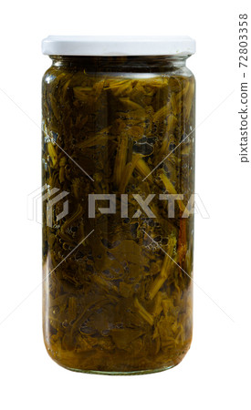 Canned green spinach in glass jar 72803358