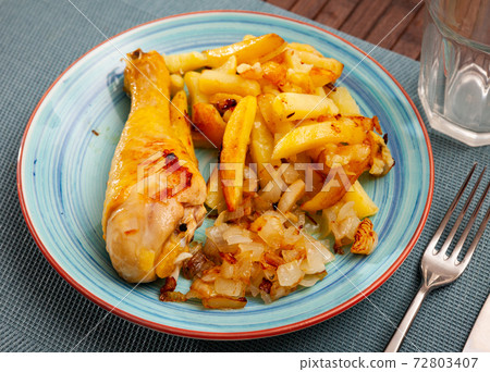 Chicken legs with fried potato and onion Chicken legs with fried potato and onion 72803407