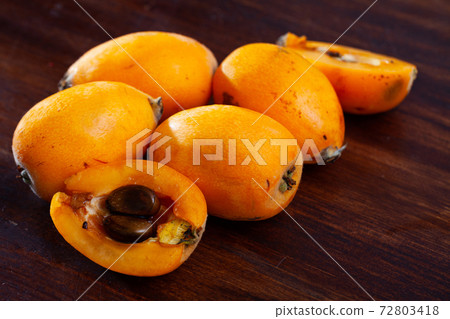 Ripe medlar fruits nispero on wooden surface 72803418