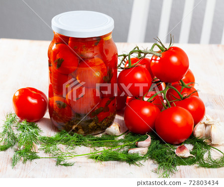 Pickled tomatoes in glass jar 72803434