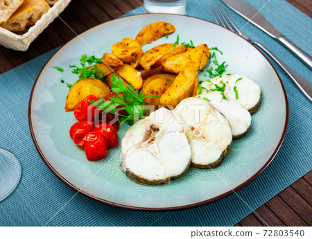Baked hake steaks with vegetable side dish Baked hake steaks with vegetable side dish 72803540