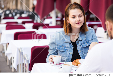 male and female traveling and drinking coffee with bakery male and female traveling and drinking coffee with bakery 72803704