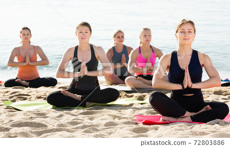Girls making yoga meditation in lotus pose 72803886