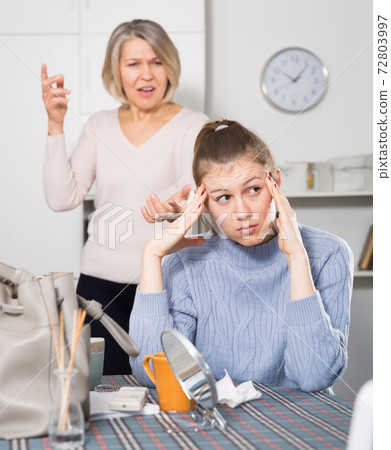 Woman scolding her daughter Woman scolding her daughter 72803997