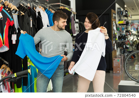 Positive couple looking sport shirt Positive couple looking sport shirt 72804540