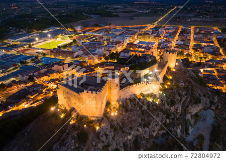 Night view of illuminated hilltop walled castle in Castalla, Spain Night view of illuminated hilltop walled castle in Castalla, Spain 72804972
