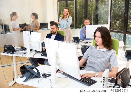 Coworkers working together in office Coworkers working together in office 72804974