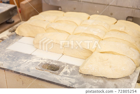 Prepared raw dough on tray in bakery Prepared raw dough on tray in bakery 72805254