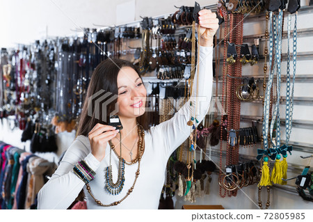 woman choosing bracelets and pendants woman choosing bracelets and pendants 72805985