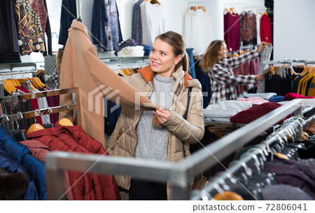 Woman shopping in outerwear clothing boutique Woman shopping in outerwear clothing boutique 72806041