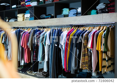 Clothes on hangers and shelves in market Clothes on hangers and shelves in market 72806042