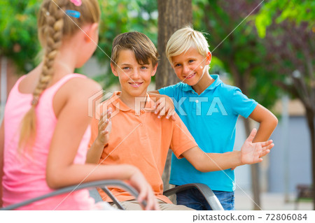 Company of children are communicating on walk 72806084