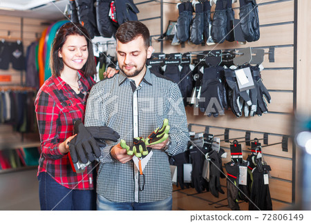 Couple bragging about buying protective gloves Couple bragging about buying protective gloves 72806149