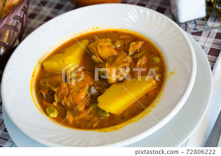 Tasty chicken with red sauce and vegetables at plate on table Tasty chicken with red sauce and vegetables at plate on table 72806222