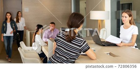 Friendly lawyer consulting his female clients Friendly lawyer consulting his female clients 72806356