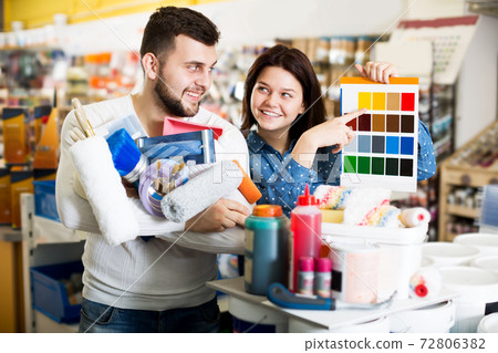 Couple examining color scheme variants Couple examining color scheme variants 72806382