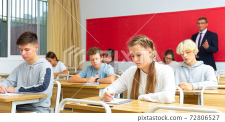 Teenage students working at class during lesson Teenage students working at class during lesson 72806527