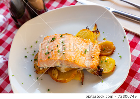 Dish of tasty baked salmon with onion and potatoes Dish of tasty baked salmon with onion and potatoes 72806749
