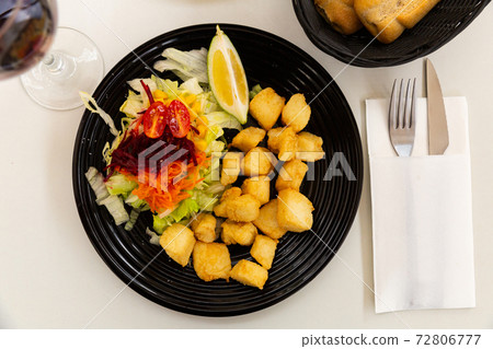 Pieces of fried cuttlefish breaded with vegetables Pieces of fried cuttlefish breaded with vegetables 72806777
