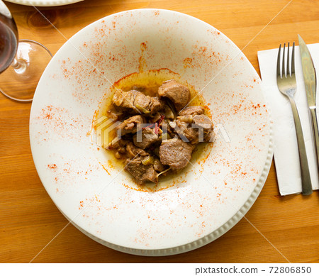 Lamb stew with garlic shoots seasoned with smoked paprika Lamb stew with garlic shoots seasoned with smoked paprika 72806850