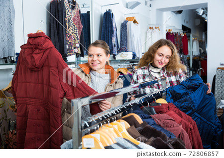 Female friends choosing new coat Female friends choosing new coat 72806857