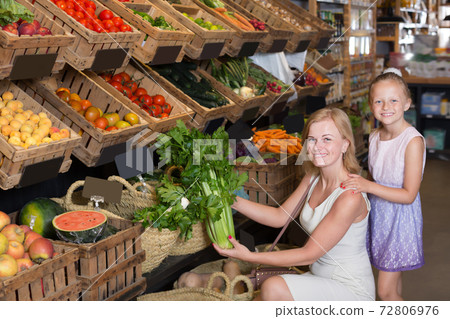 Portrait of adult woman and girl buying greens Portrait of adult woman and girl buying greens 72806976