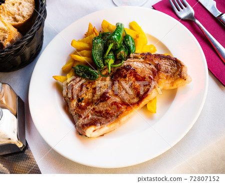 Steak of beef sirloin with fried potatoes and baked jalapenos Steak of beef sirloin with fried potatoes and baked jalapenos 72807152