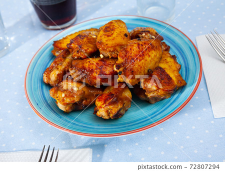 Tasty crispy grilled chicken wings on plate Tasty crispy grilled chicken wings on plate 72807294
