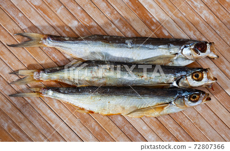 Image of air-dried salted sabrefish on wooden background 72807366