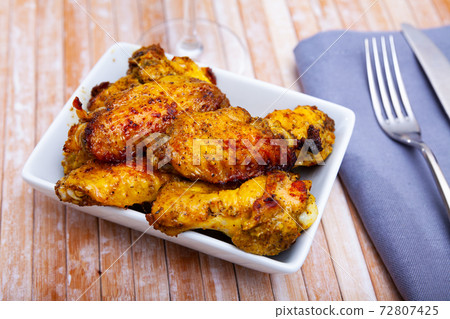 cooked and served on white plate chicken wings for dinner cooked and served on white plate chicken wings for dinner 72807425