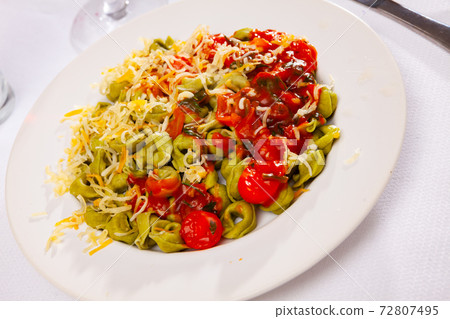 Spinach tortellini with vegetable sauce and grated cheese 72807495
