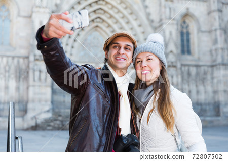 tourists taking selfie on mobile phone tourists taking selfie on mobile phone 72807502