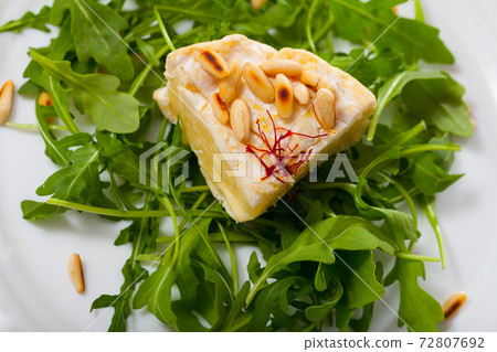 Camembert on arugula with pine nuts Camembert on arugula with pine nuts 72807692