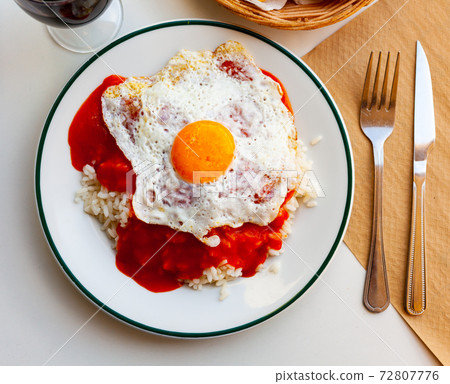 Cuban style rice with gravy and scrambled eggs closeup 72807776