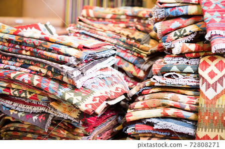 Stack of traditional colorful carpets in carpet shop Stack of traditional colorful carpets in carpet shop 72808271